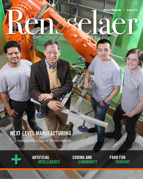John Wen and team with robotic manufacturing arm in background