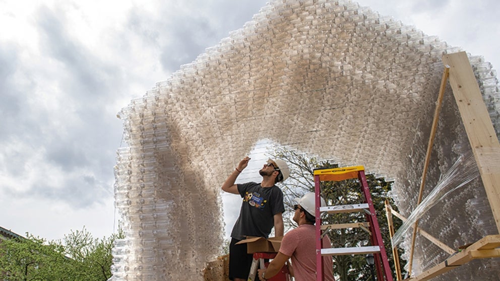 Students use empty plastic water bottles to construct a shelter