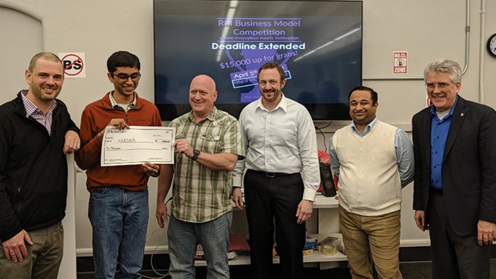 Clint Ballinger (holding check, center), Executive Entrepreneur in Residence at the Severino Center, presents the award to Kapila Chandramouli ’18 of Kapshur Medical Devices (formerly HARSHA).