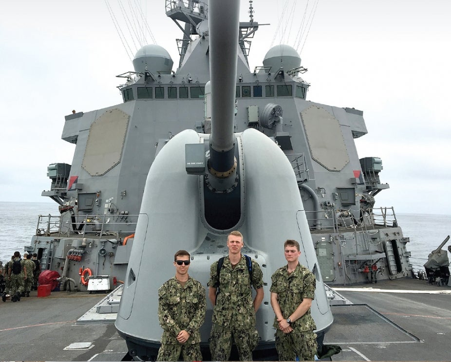 Rensselaer students standing in front of a gun on a Navy ship