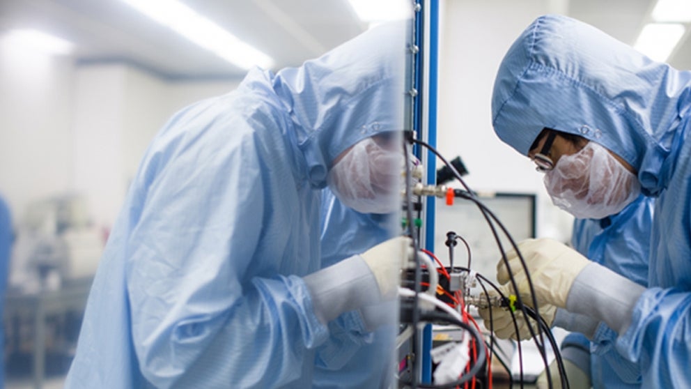 Researchers working in a clean room