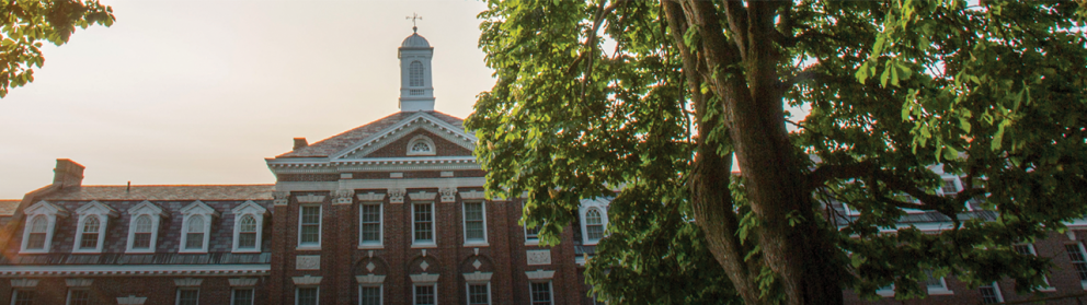 Rensselaer building with cupola on top at dusk.