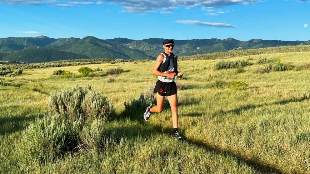 Former student-athlete running through field