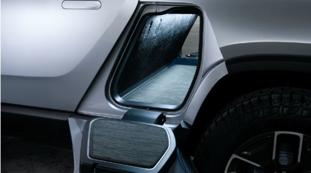 Pass through storage on Rivian is large enough for a surfboard