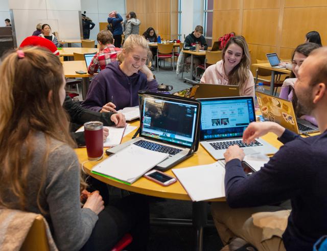 Group of students sitting around a table in discussion