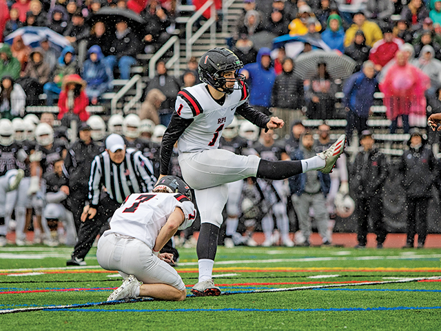 Trevor Bisson kicking a field goal 