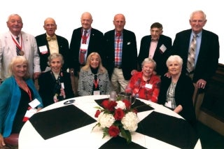 From left, standing with their wives, Glenn Brown ’54, Gus Albern ’54, Henry Rosenblatt ’54, Bob Thieringer ’54, Bob Meade ’54, and Jim Shildneck ’54.