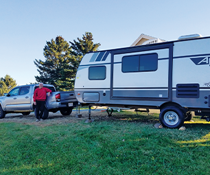  Chuck Rancourt in front of his travel trailer